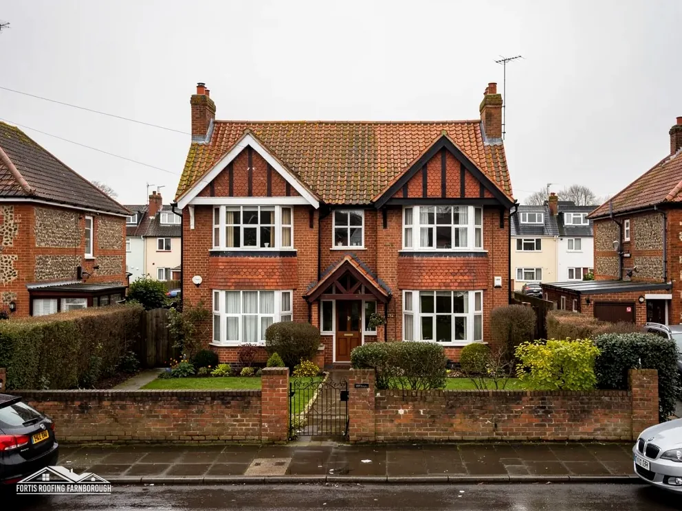 Edwardian brick villa with a red tile roof, gables and timber detailing